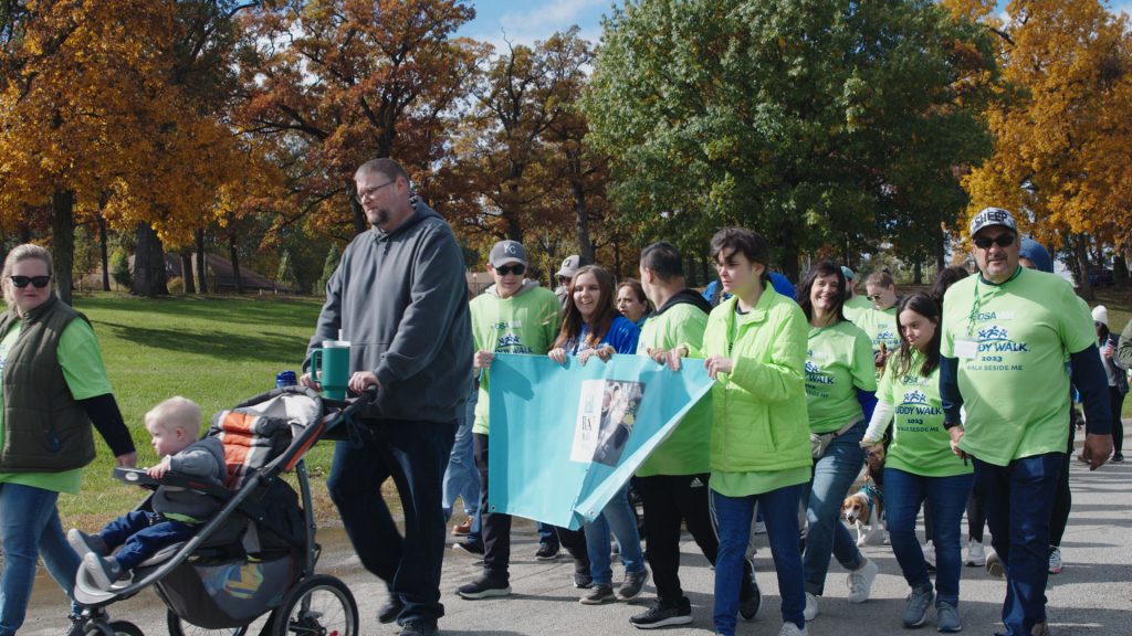 Families walking together on a fall morning at the Buddy Walk Family Fun Day
