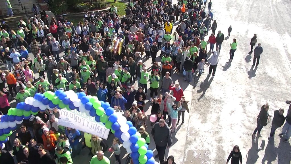 Walkers heading out under the Buddy Walk Family Fun Day balloon arch