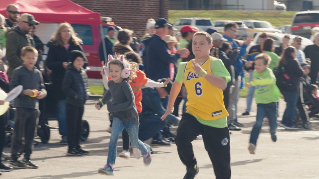 Children running and playing together at a DSANWI community event