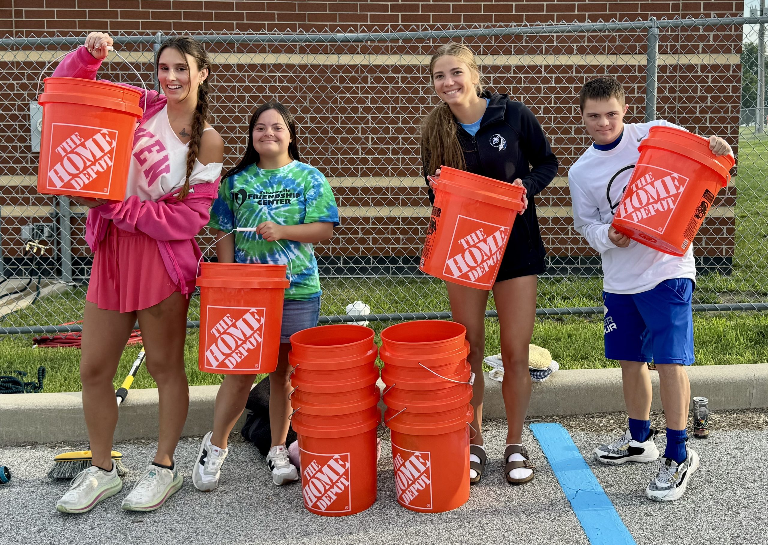DSANWI teens and volunteers outside with buckets and supplies for a community fundraiser
