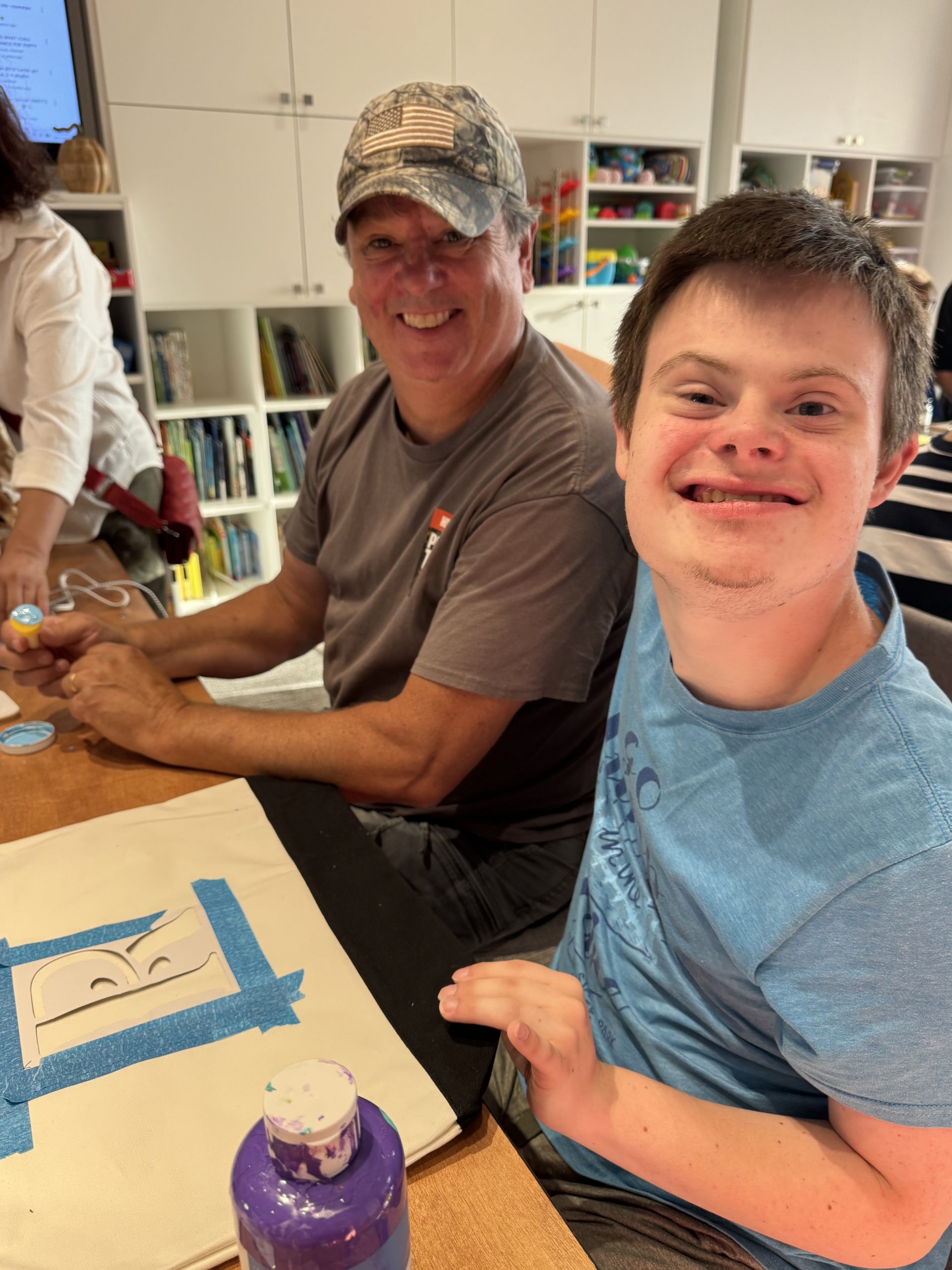 A DSANWI volunteer and a young man working on a project together