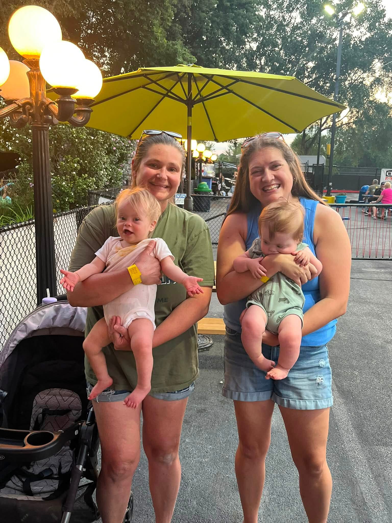 Two moms holding their babies together at a DSANWI family outing