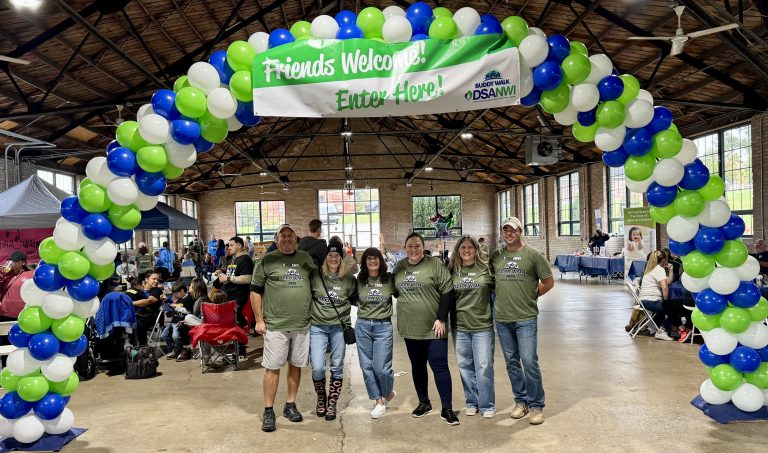 DSANWI families gathered under the Buddy Walk balloon arch
