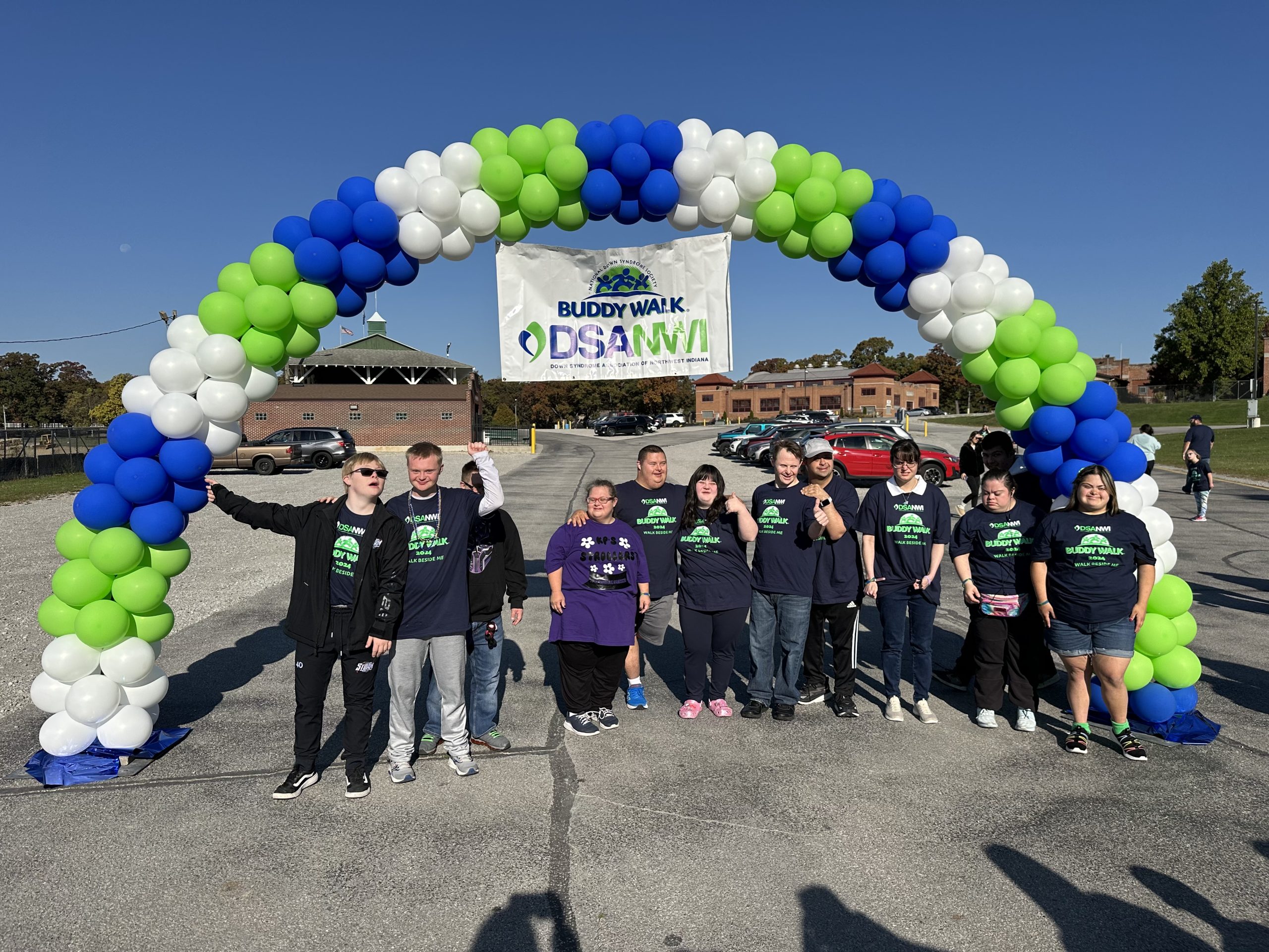 Buddy Walk participants gathered under the balloon arch beneath the DSANWI Buddy Walk banner