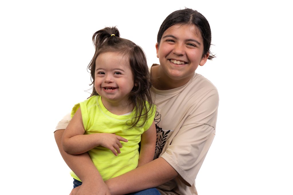 Two young DSANWI community members smiling together